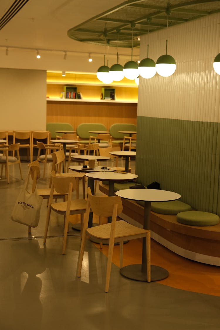 Tables And Chairs Near Lamps In Restaurant