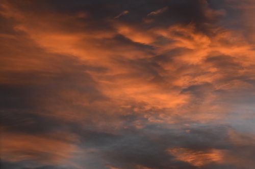 Free A beautiful twilight sky with ethereal clouds illuminated in warm hues. Stock Photo