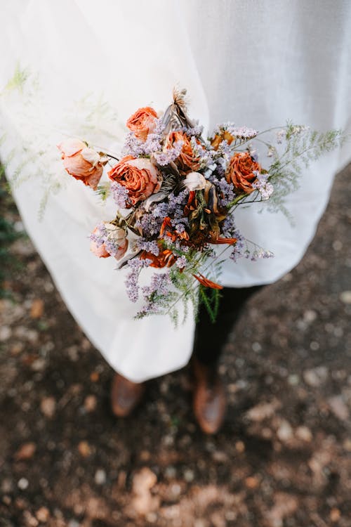 Close up of Person Standing with Flowers Bouquet