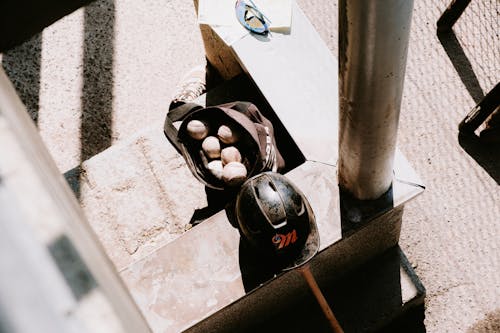 Helmet and Bag with Balls on Sunlit Wall