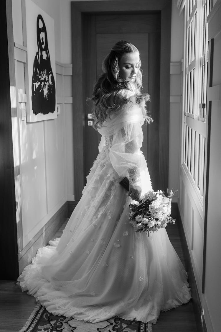 Bride Posing In Wedding Dress On Corridor