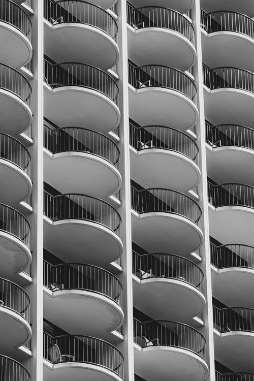 Free Black and white photo of modern curved balconies creating geometric patterns. Stock Photo