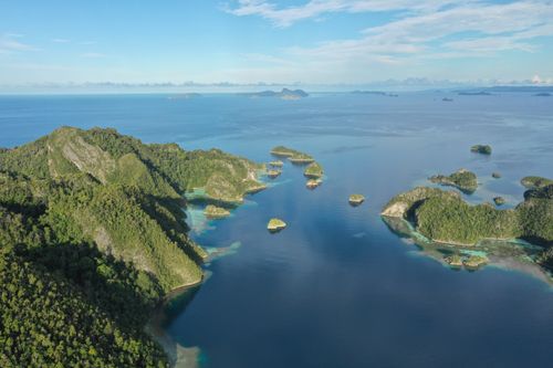 Free Explore the stunning aerial vista of Raja Ampat's lush islands and azure waters in Indonesia. Stock Photo