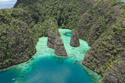 Stunning aerial shot of a tropical lagoon in Raja Ampat, Indonesia, showcasing vibrant turquoise water and lush greenery.