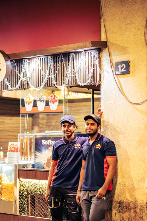 Men in Caps Working at Food Bar