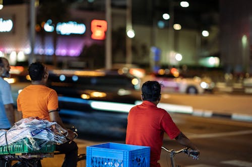 Men on Bikes in City at Night