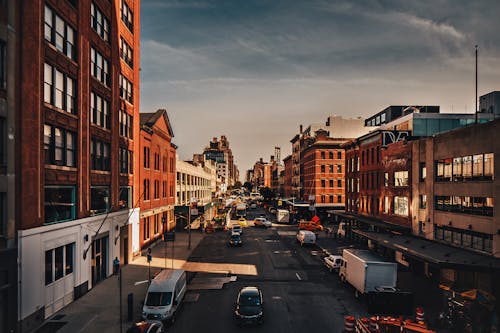 Photo of Vehicles on Road Near Buildings