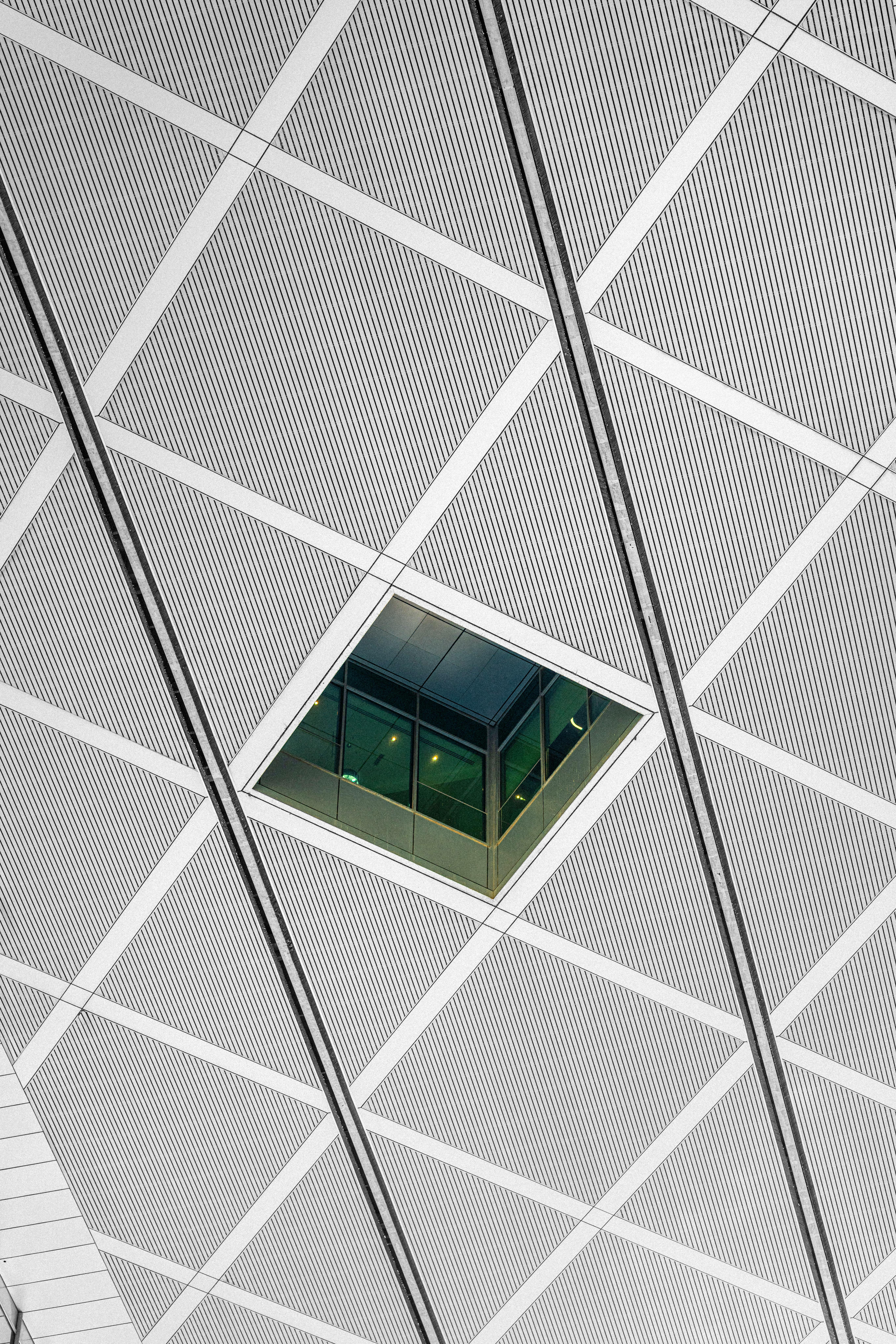 Low angle view of a patterned ceiling with a glass window in Dubai.