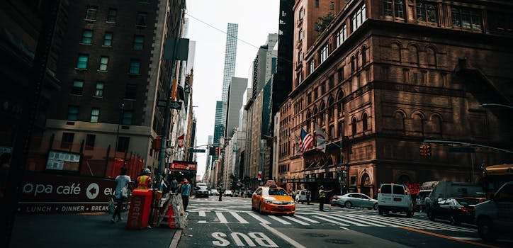 Vibrant New York City street with yellow taxi, skyscrapers, and city life captured in Midtown Manhattan.