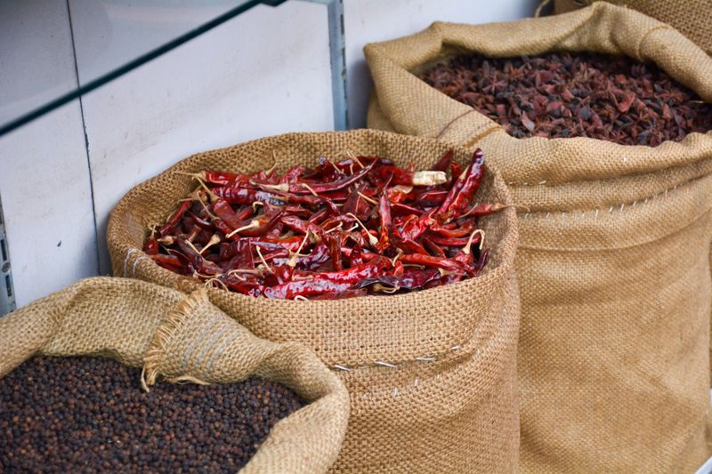 Burlap sacks of vibrant export-grade spices ready for shipment