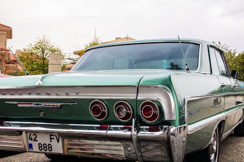 Rear View of Green Vintage Chevrolet Impala Car