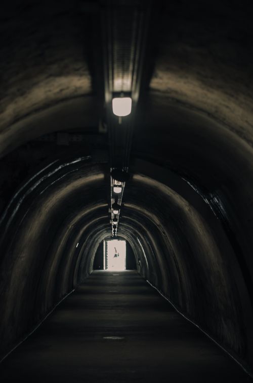 Free Moody tunnel image showcasing symmetry and perspective with a central light source. Stock Photo