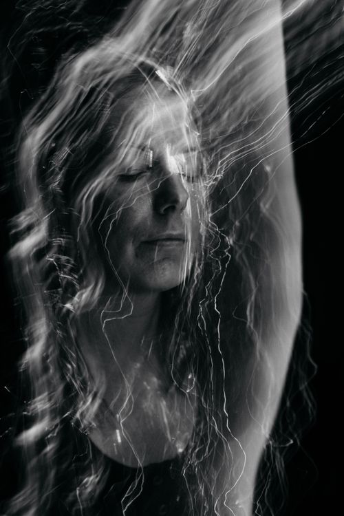 Free Abstract black and white portrait capturing a woman with eyes closed and motion blur effect. Stock Photo