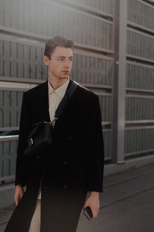 Model in Coat with Bag and Smartphone