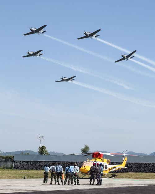 Free Thrilling aerobatic airshow with aircraft and military in Manado, Indonesia. Stock Photo