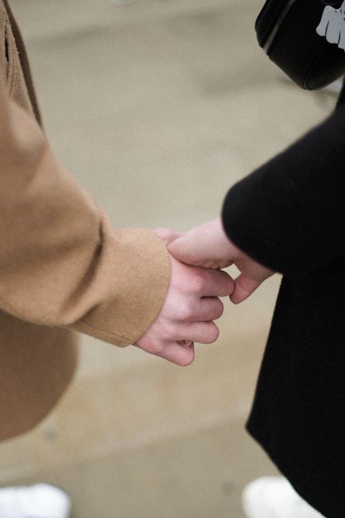 Free Close-up of a couple holding hands, symbolizing love and unity in Ternopil, Ukraine. Stock Photo