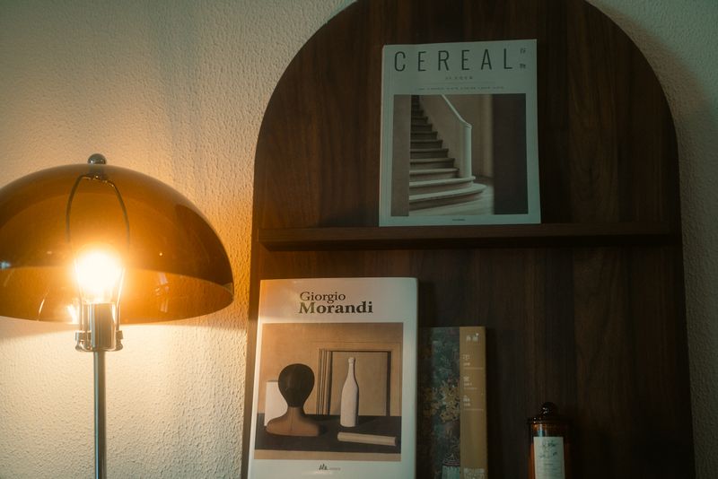 Quiet reading nook styled in a Miami home with a tailored chair and lamp