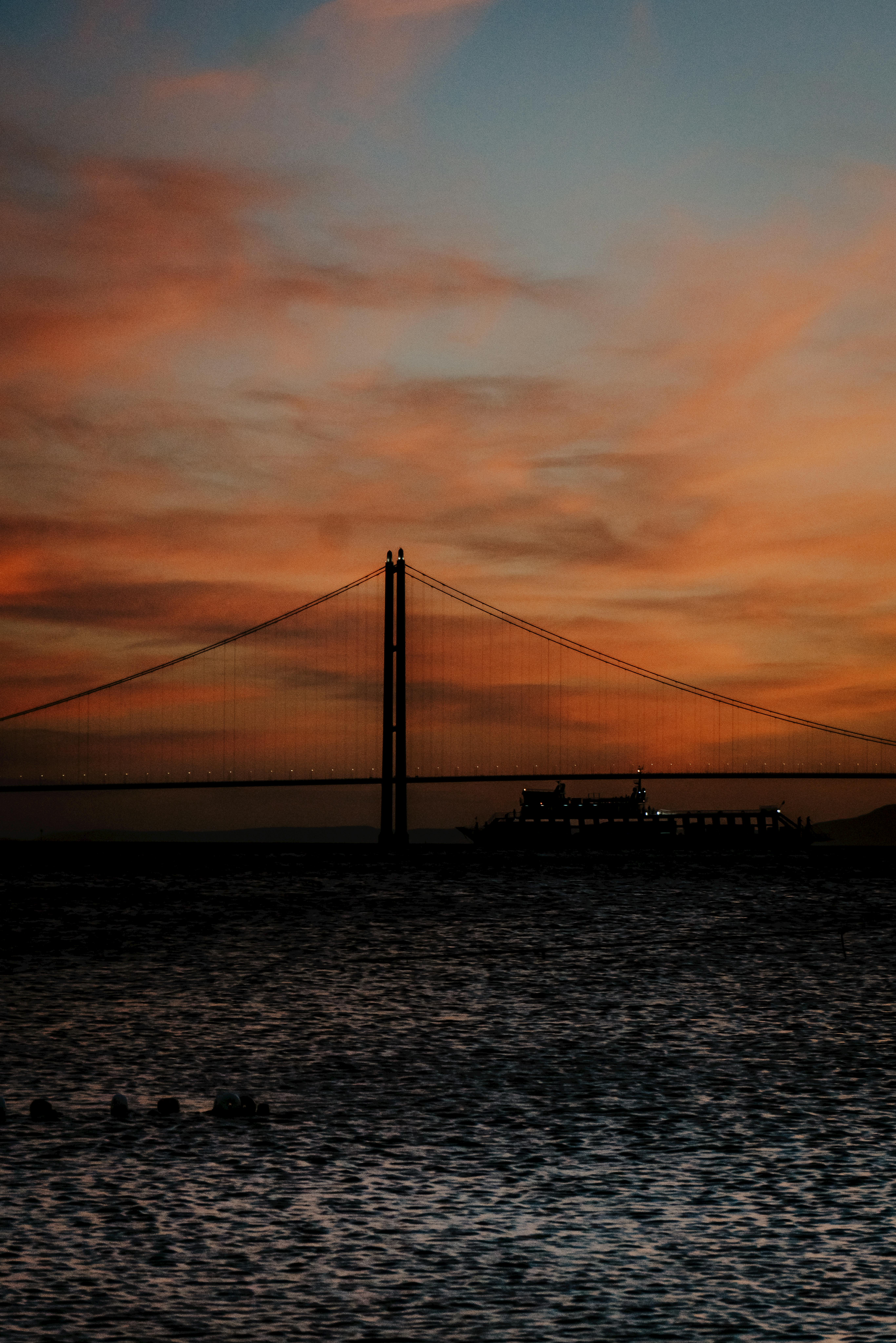 A stunning silhouette of a bridge at sunset over water in Lapseki, Çanakkale, Türkiye.