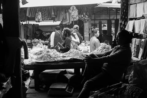 Customers and Vendors at Stalls in the Market