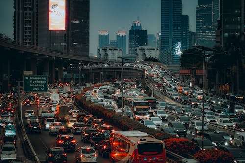 Cityscape with Traffic Jam on a Multi Lane Overpass at Evening