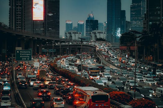 A vibrant evening cityscape capturing the busy traffic of Jakarta with skyscrapers in the background.