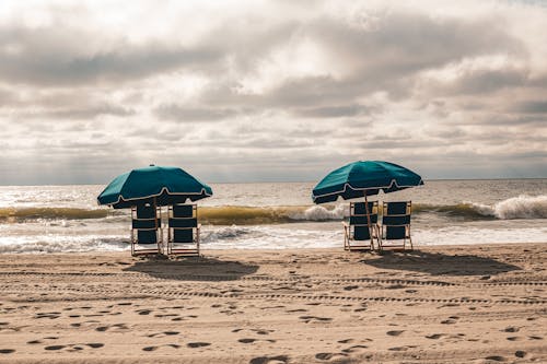 Sunbeds with Beach Umbrellas on Beach