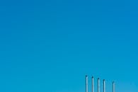 View of the Tops of Poles against Clear Blue Sky