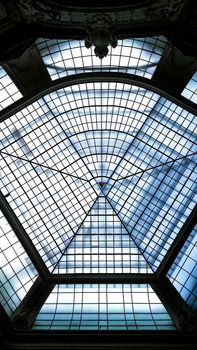 A captivating view of an intricate glass ceiling with geometric design at a historic building.