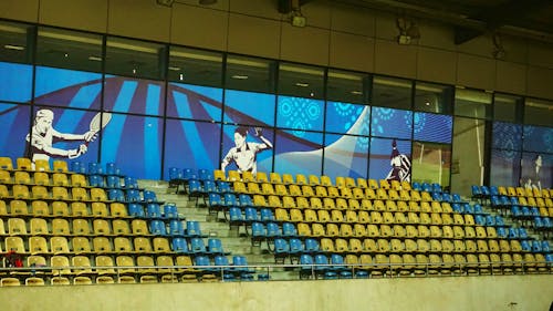 Yellow and Blue Seats Inside Court