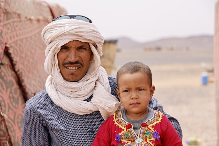 A Man In A Turban Holding His Baby 