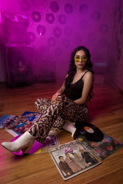 Stylish woman in retro club scene with vinyl records