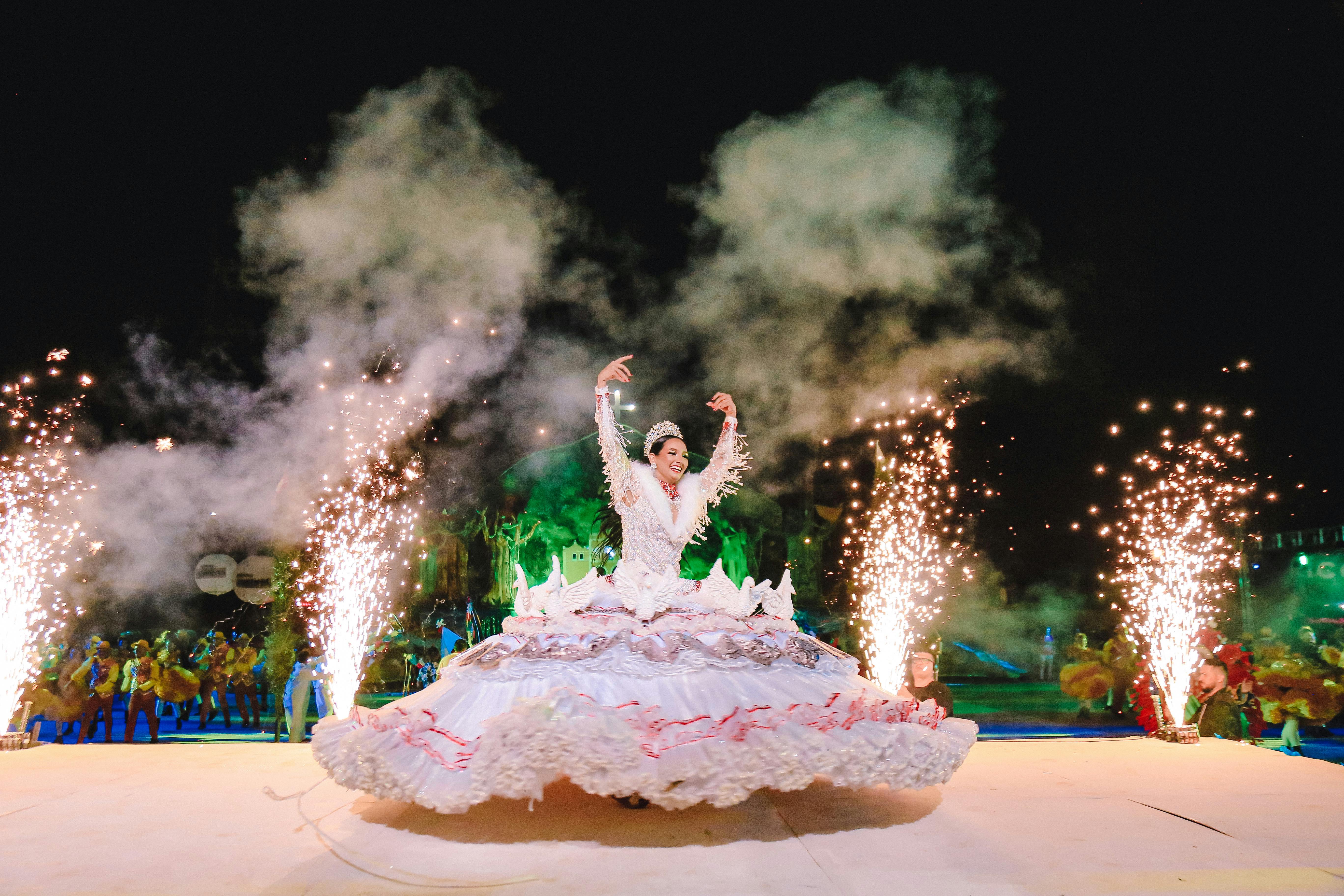 Energetic nighttime dance performance featuring grand dress and dazzling fireworks.
