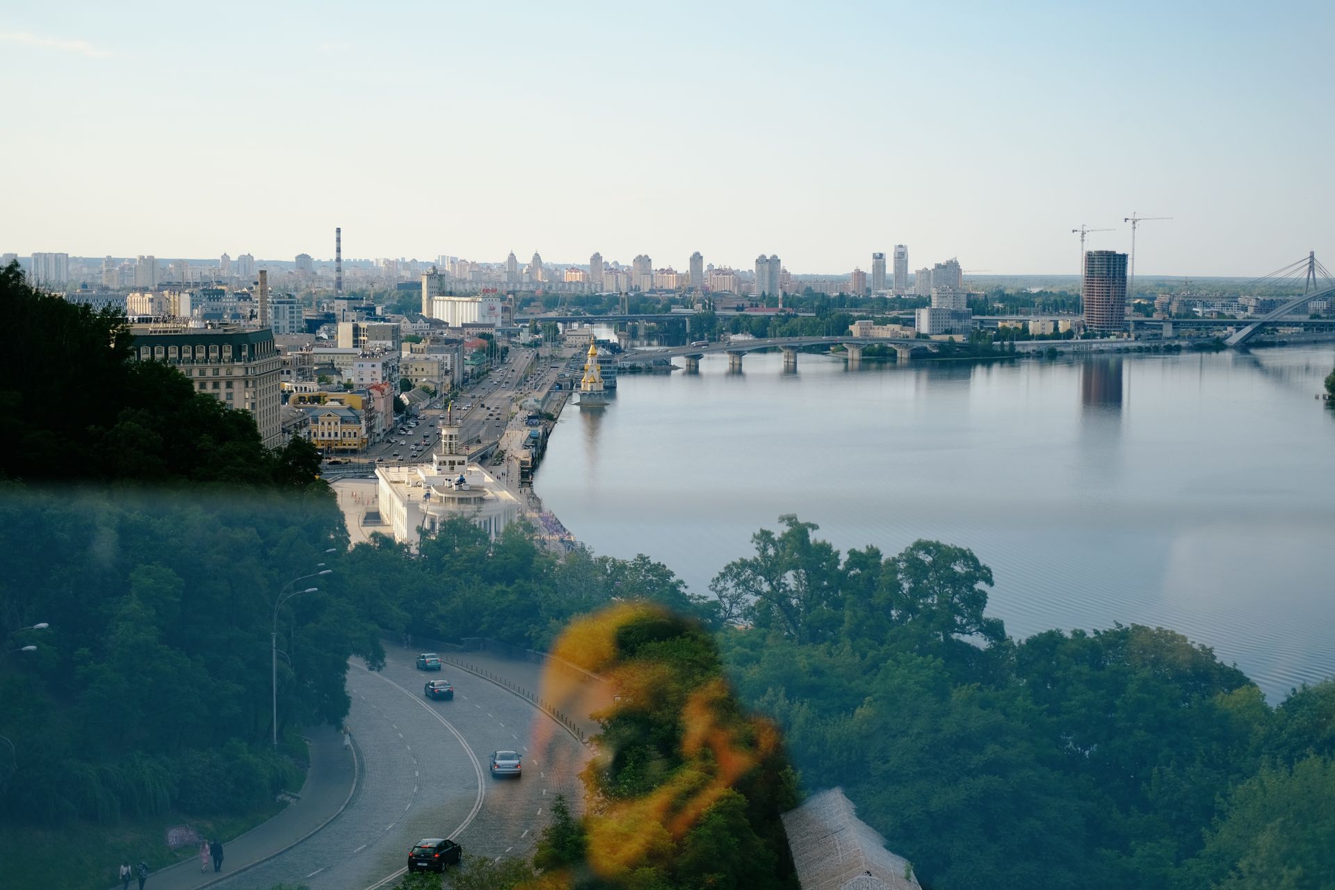 Scenic aerial view of Kyiv, Ukraine featuring the Dnipro River and urban landscape.