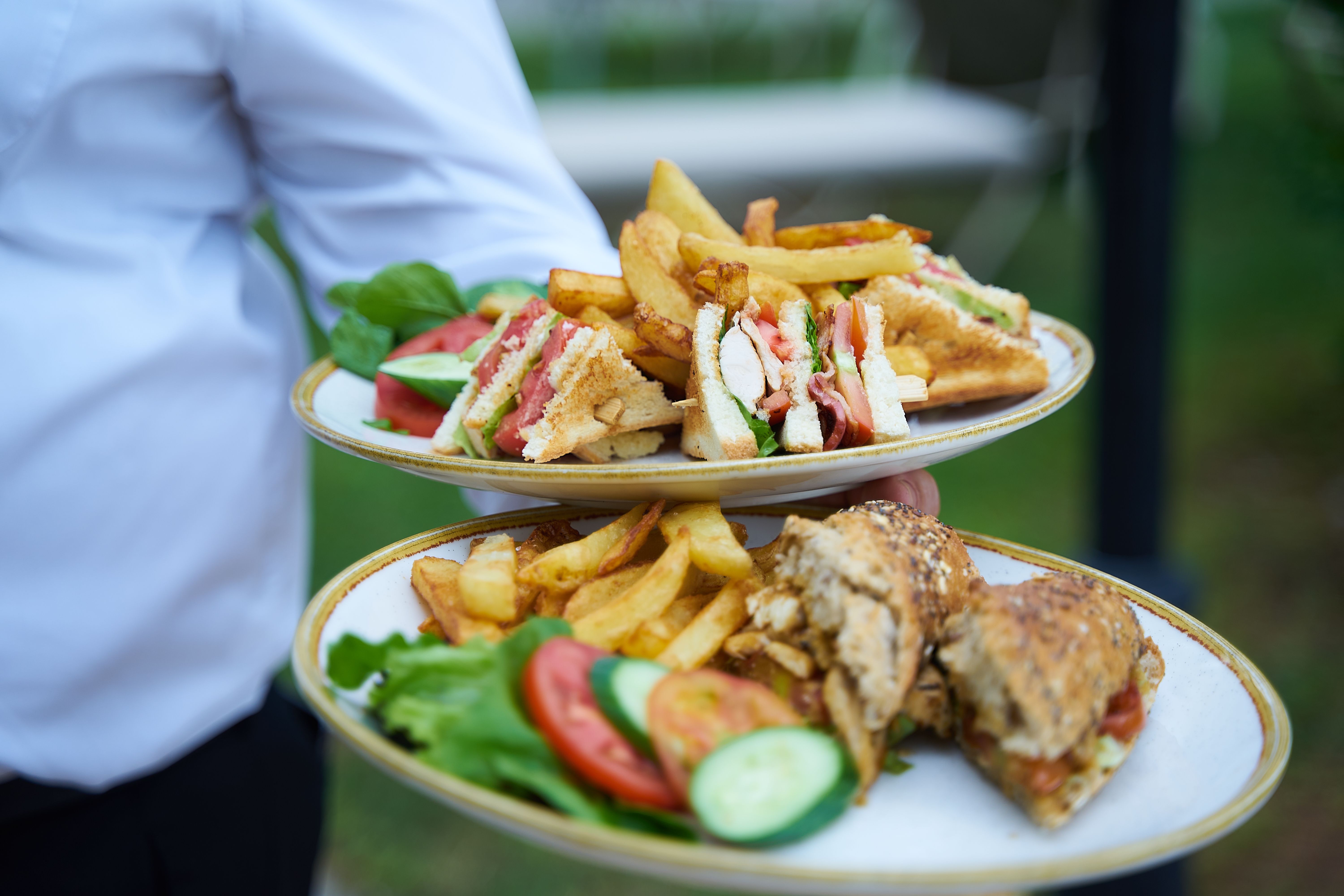 Selection of fresh sandwich ingredients including bread, meats, and vegetables