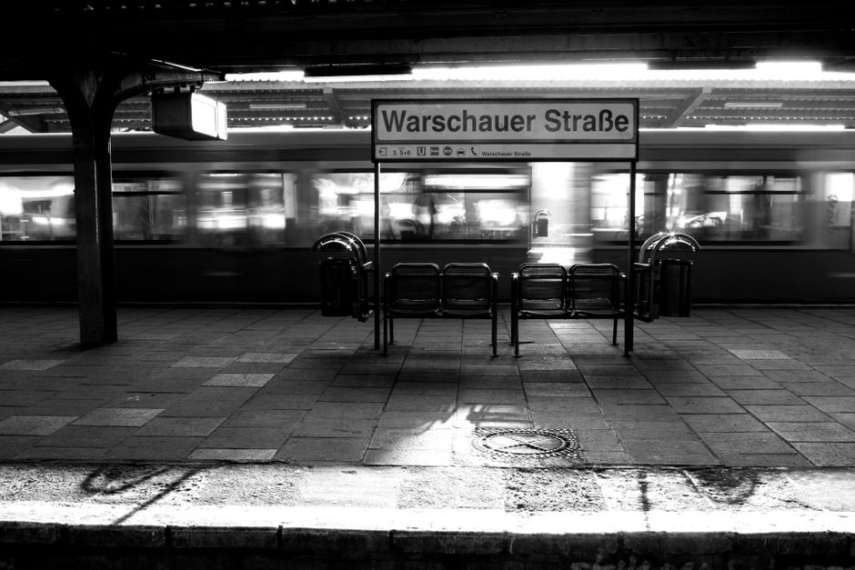 Dramatic black and white photo of Warschauer Straße railway platform in Berlin, Germany.