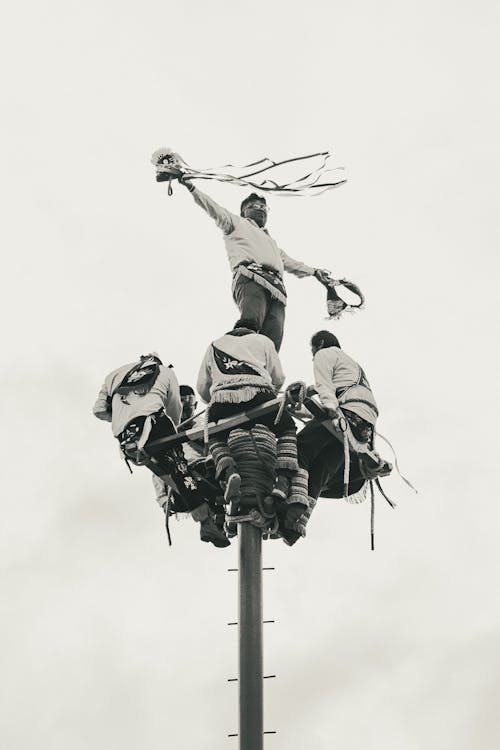 Men on Pole in Festival in Black and White