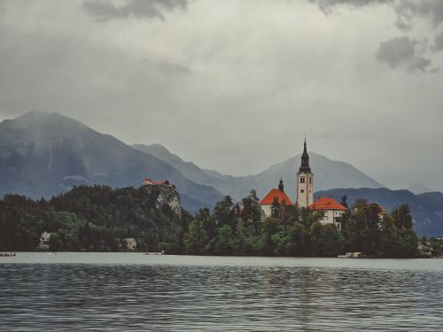 Free A breathtaking view of Lake Bled with the Church of the Assumption and surrounding mountains in Slovenia. Stock Photo