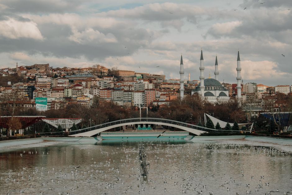 Captivating landscape of Ankara featuring a bridge and prominent mosque by the river.