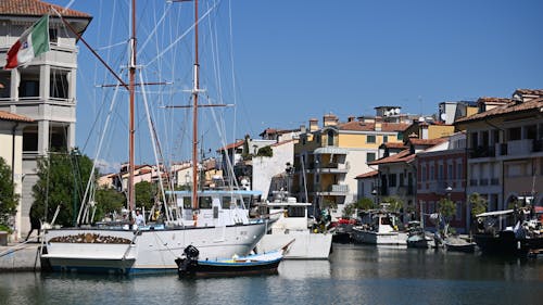 Waterfront Houses with a Sailboat Moored in the Foreground