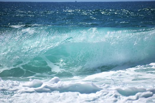 Vibrant ocean wave crashing on a sunny day, showcasing nature's power and beauty.