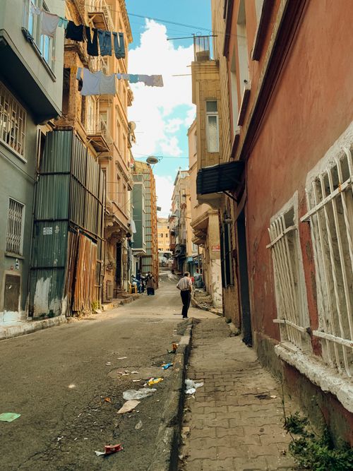 Free A quiet urban alley with hanging laundry and a street scene in a residential neighborhood. Stock Photo