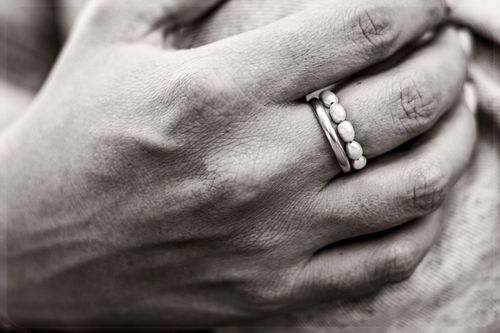 Free Black and white photo of a hand with rings, showcasing elegant jewelry details. Stock Photo