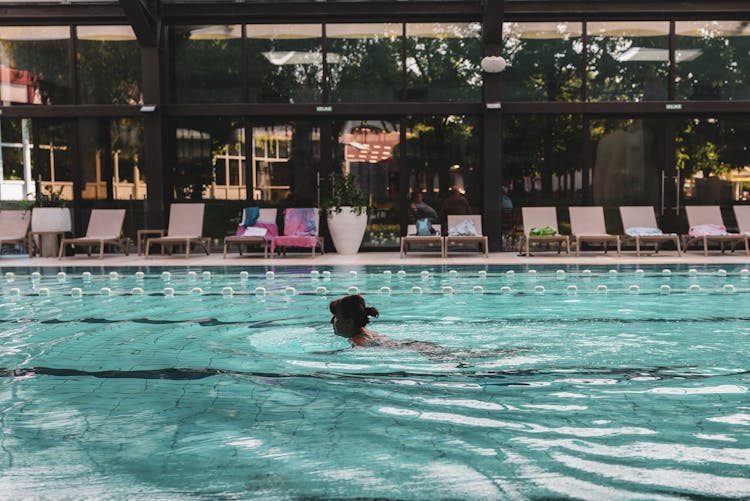 Woman Swimming In Swimming Pool