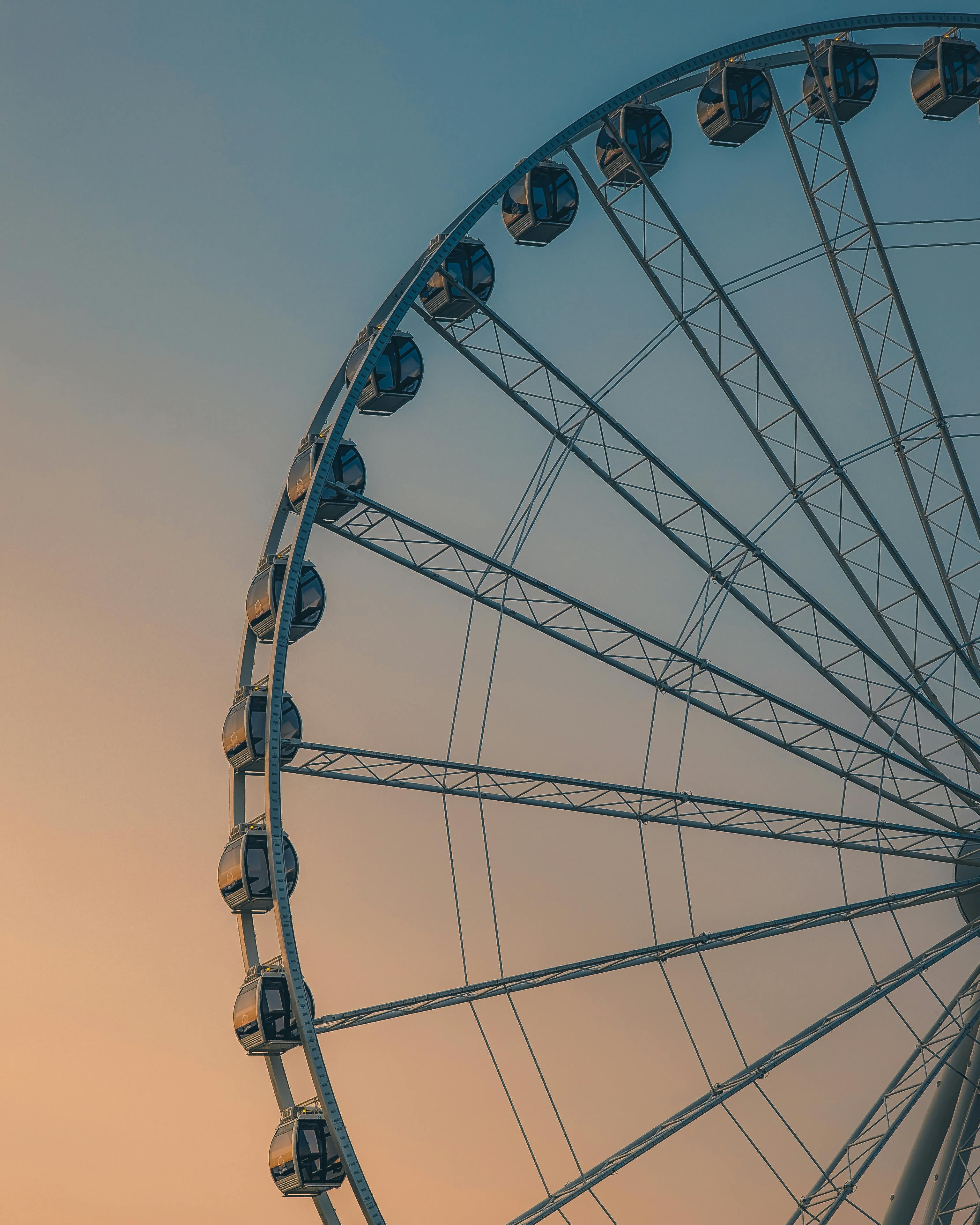 A stunning view of the Seattle Great Wheel captured at sunset, showcasing an urban skyline.