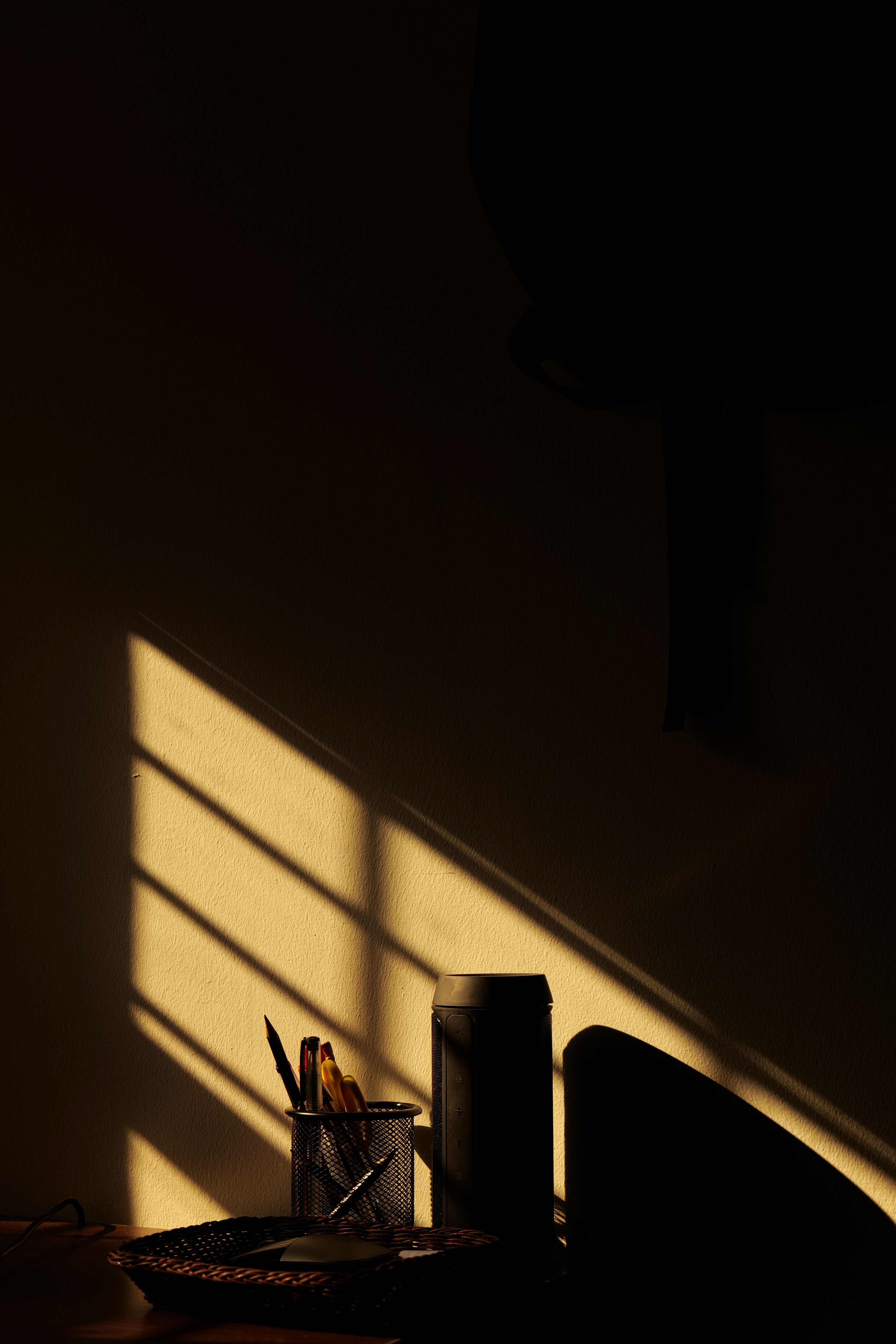Late golden light falling through a window onto a wall