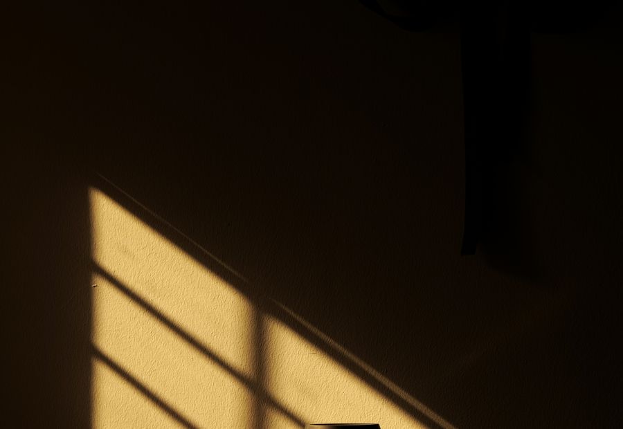 Late golden light falling through a window onto a wall