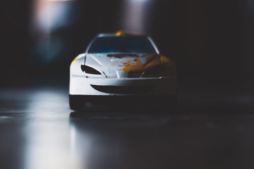 Free Detailed shot of a toy car with focus on the headlights and hood, showcasing depth of field. Stock Photo