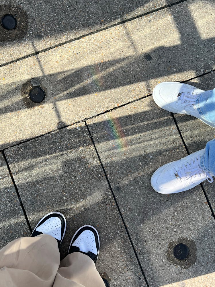 Shoes Of People Standing On Pavement