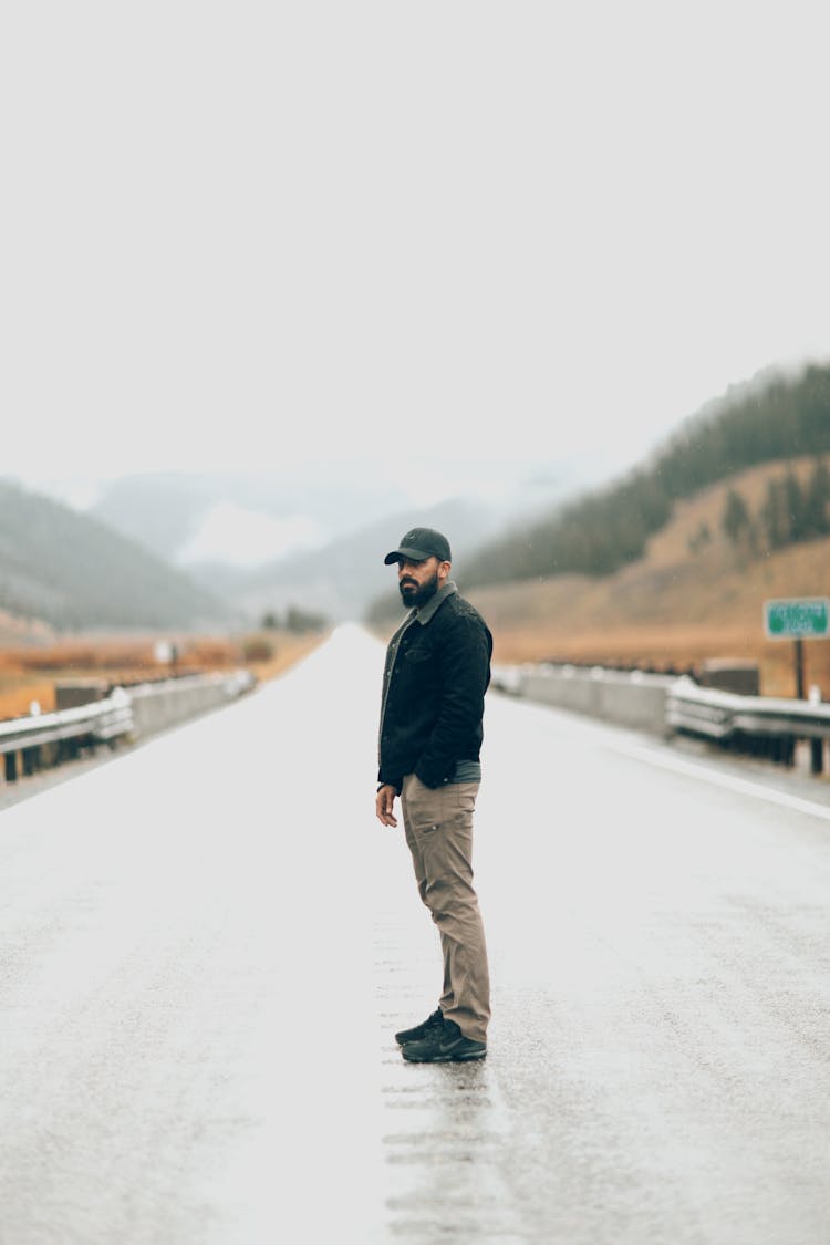 Man In Cap Standing On Road