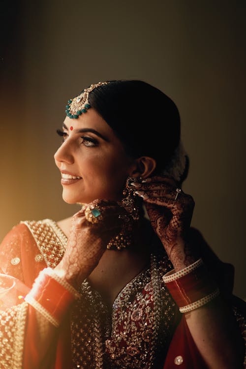 Smiling Woman in Traditional Clothing, with Jewelry and Henna Tattoos
